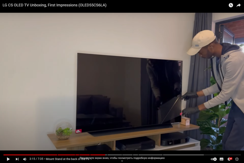 A man unpacks a new TV